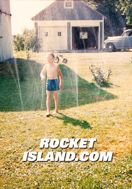 Boy Playing in the Sprinklers