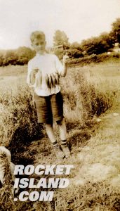 A boy holding six fish he has caught